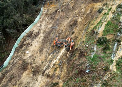 Trailer rig suspended from cliff top used for soil nailing